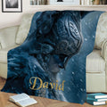 Close-up Viking warrior throw blanket displayed across a sofa with dark blue fantasy-inspired artwork