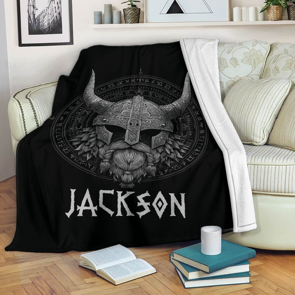 Viking throw blanket draped over a sofa with a detailed Norse warrior design in black and silver