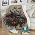 Viking blanket draped over a sofa with ornate helmet artwork, floral accents, and a cozy reading setting
