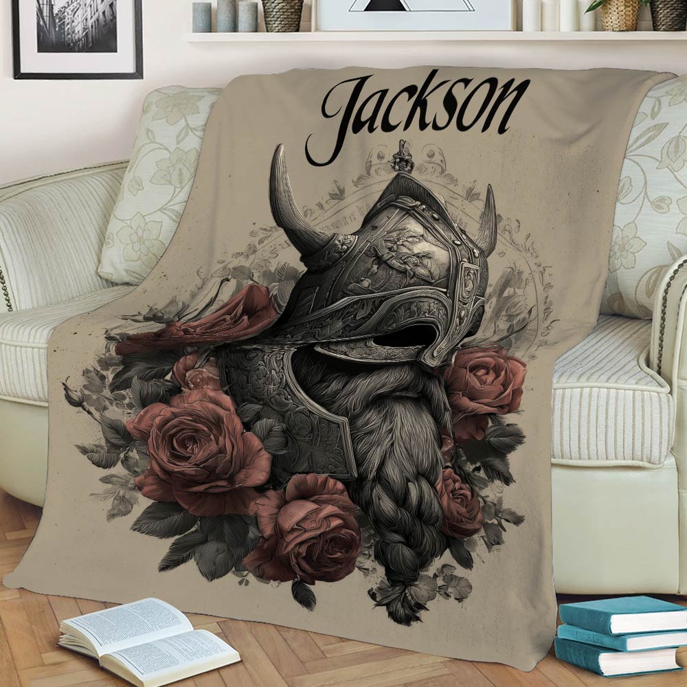 Viking throw blanket displayed on a couch with detailed Norse helmet artwork and muted red roses
