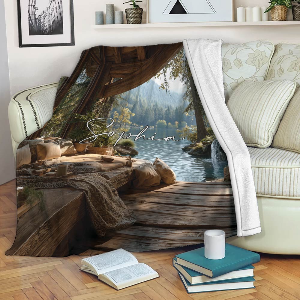 Lake house blanket draped over a sofa with scenic forest lake, cabin deck, and peaceful retreat artwork