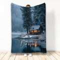 Lake house blanket with snowy lakeside cabin, evergreen trees, and reflective water artwork