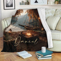 Lake House Throw Blanket draped over a sofa with autumn lake scenery, dock, boat, and warm firelight