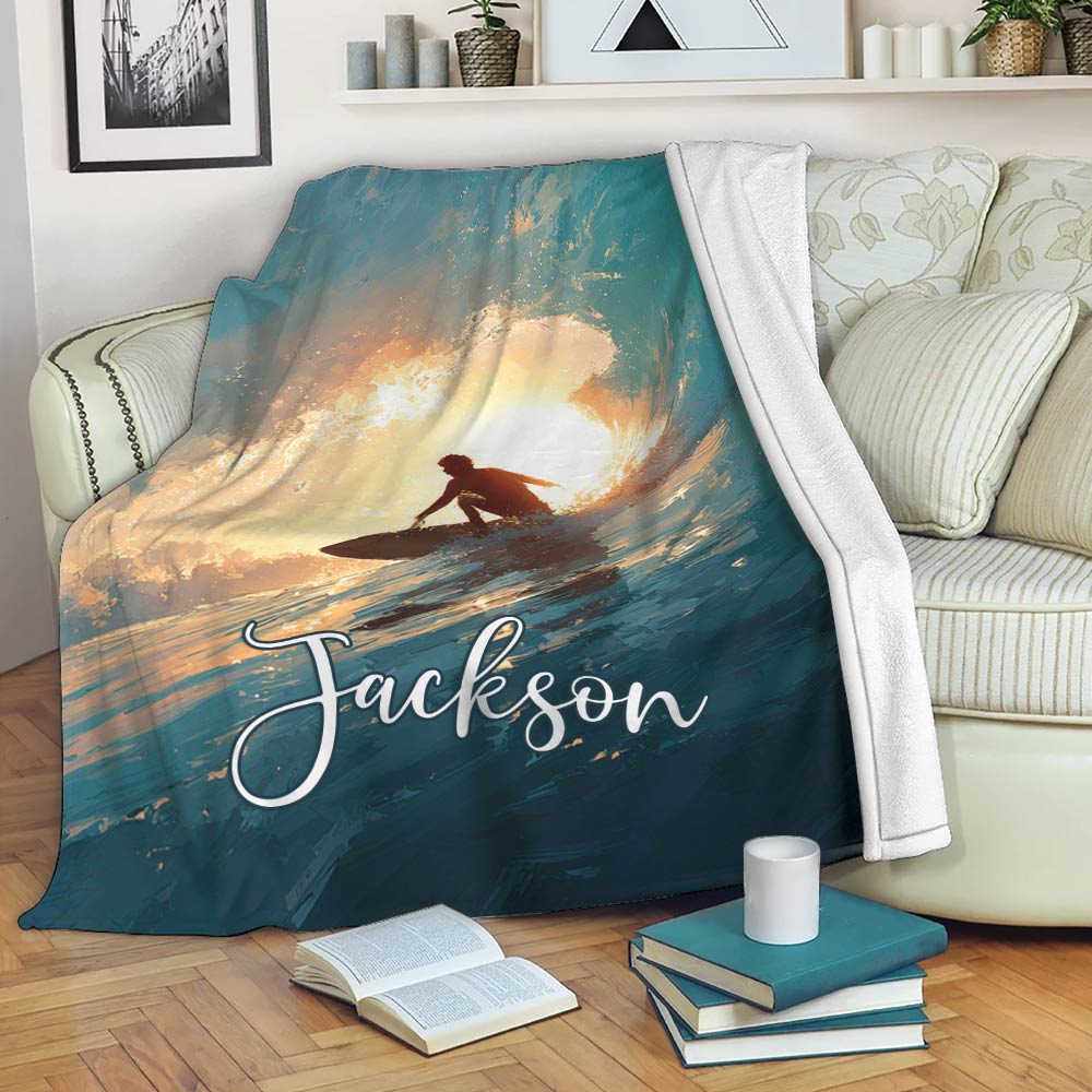 Surfing throw blanket draped over a sofa with expressive ocean wave and sunset artwork