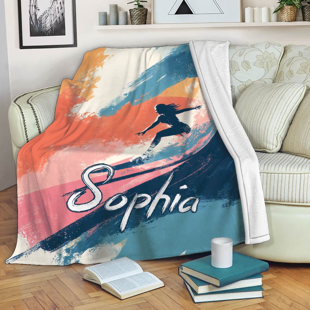 Colorful surfing blanket draped over a sofa with bold wave artwork and surfer silhouette