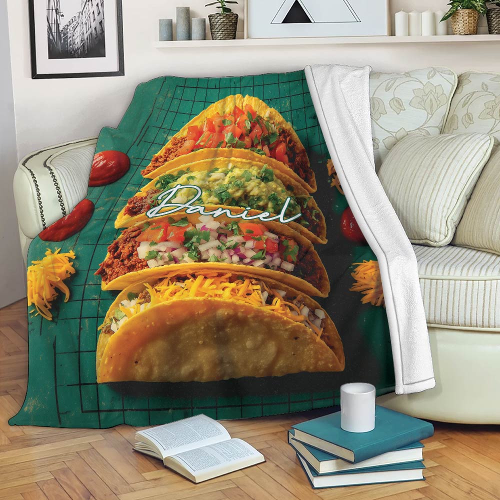 Taco blanket draped across a sofa with vibrant taco artwork in a cozy living room setting