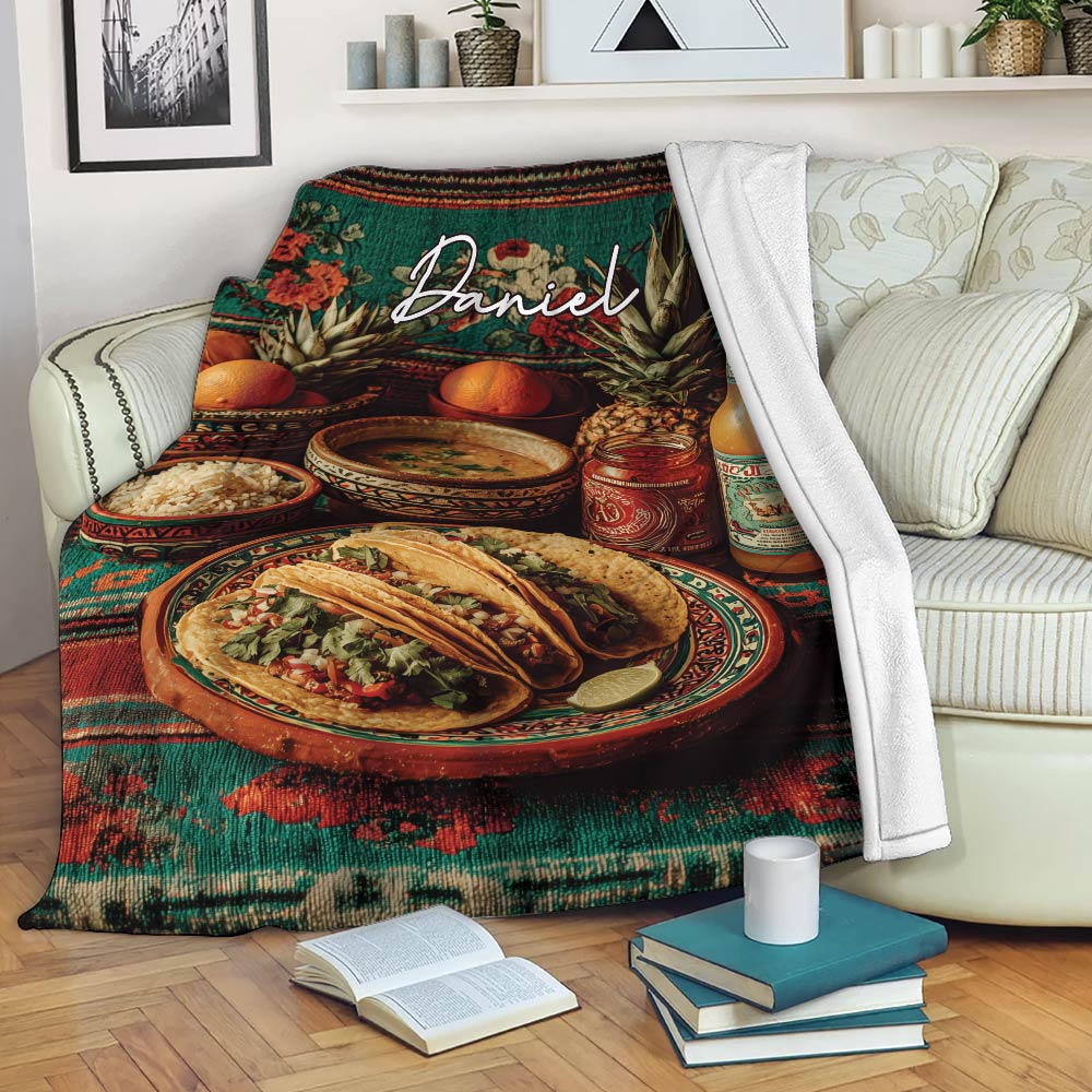 Taco blanket styled on a sofa with plated tacos, colorful food artwork, and a cozy living room setting
