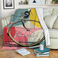 Bicycle throw blanket draped over a sofa in a cozy living room setting