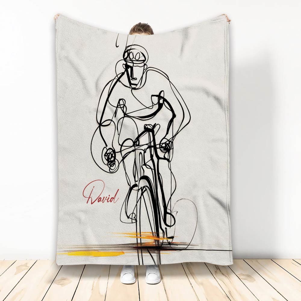 Bicycle blanket featuring bold black line art of a cyclist riding against a white background