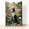 Tuxedo cat blanket featuring a black-and-white cat surrounded by colorful botanical flowers