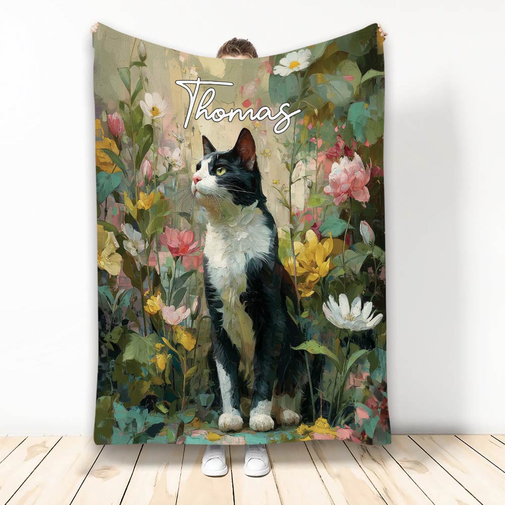 Tuxedo cat blanket featuring a black-and-white cat surrounded by colorful botanical flowers