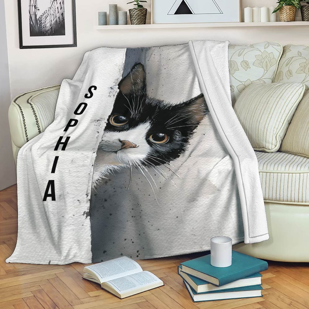 Tuxedo cat throw blanket draped over a sofa, displaying dramatic black-and-white feline artwork