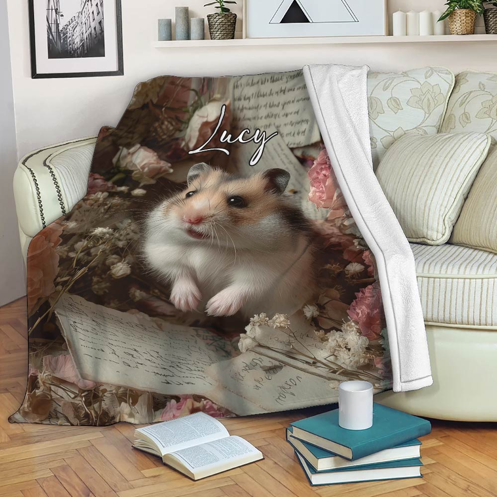 Hamster blanket displayed on a sofa with floral artwork, books, and a cozy reading nook