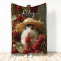 Hamster wearing a straw hat and holding a raspberry among painted berries and foliage