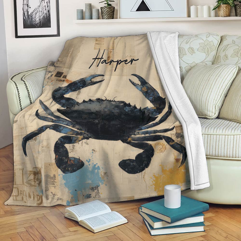 Crab blanket draped over a sofa in a cozy reading space with vintage collage artwork and coastal colors