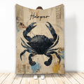 Crab throw blanket displayed upright with vintage collage artwork in black, blue, tan, and muted coastal colors