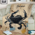 Large crab throw blanket styled on a sofa, featuring distressed vintage artwork in black, blue, and tan