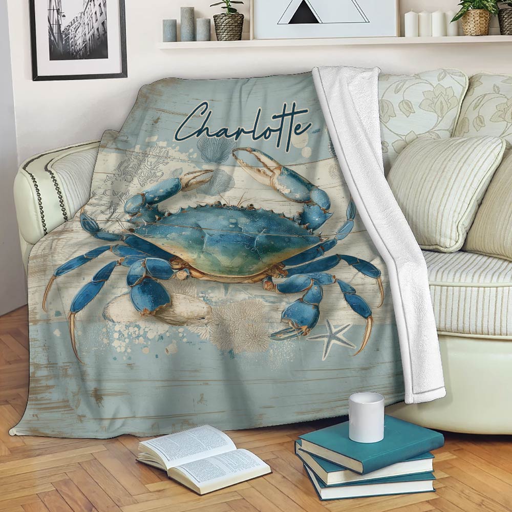 Blue crab blanket draped over a sofa with relaxed coastal living room decor