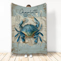 Blue crab throw blanket with coastal artwork and weathered seaside wood design