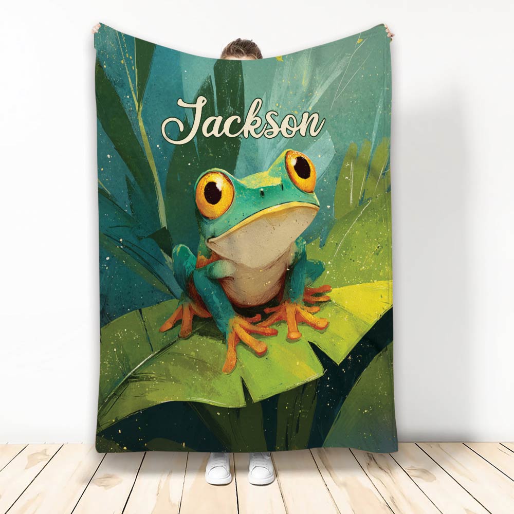 Frog throw blanket featuring a colorful green frog perched on lily pads in a lush illustrated design