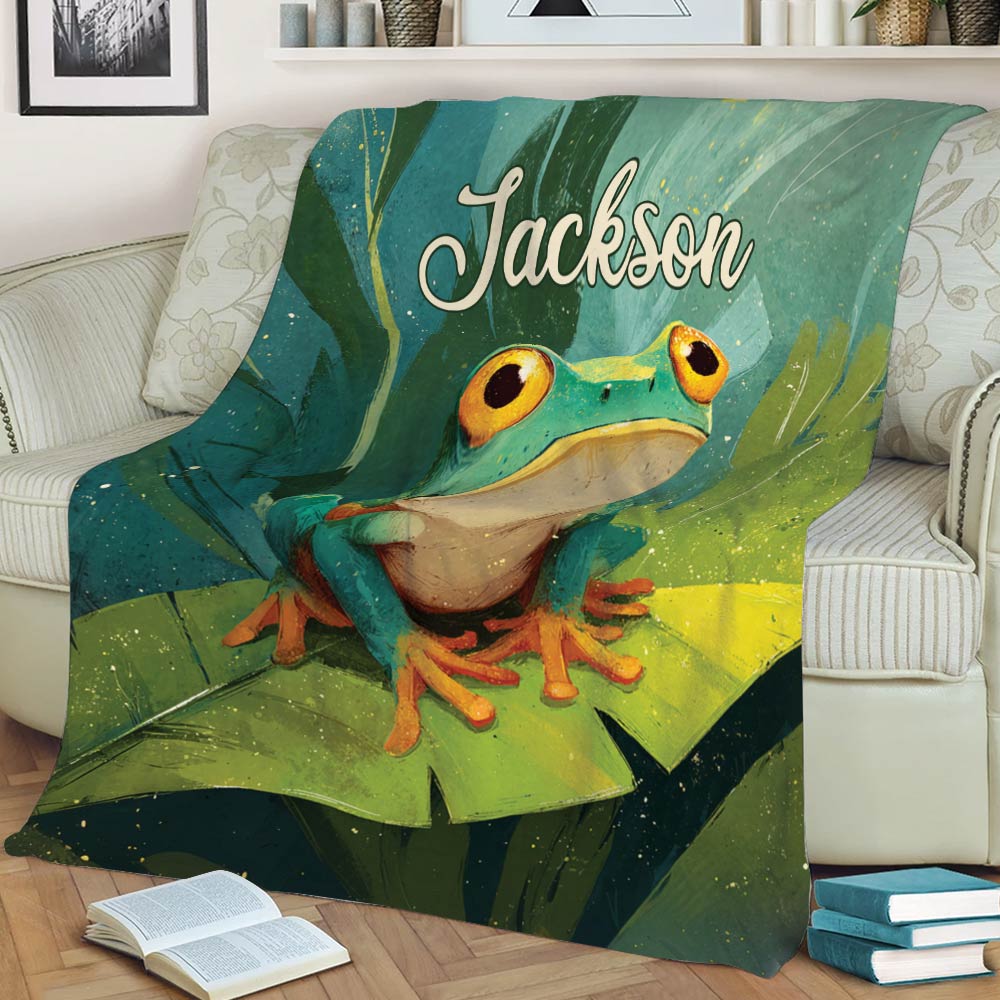 Close lifestyle view of a frog throw blanket with a bright green frog and tropical lily pad artwork