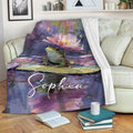 Colorful frog throw blanket draped over a sofa, featuring a lily pad pond design in artistic jewel tones
