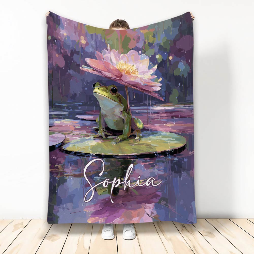 Frog blanket featuring a colorful lily pad pond scene with painterly purple, pink, green, and blue artwork
