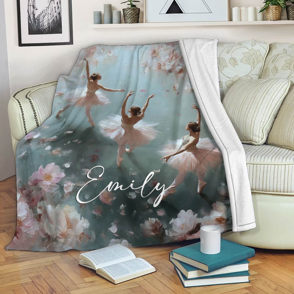 Floral ballet blanket displayed on a sofa with graceful ballerina artwork in blush pink and soft aqua tones