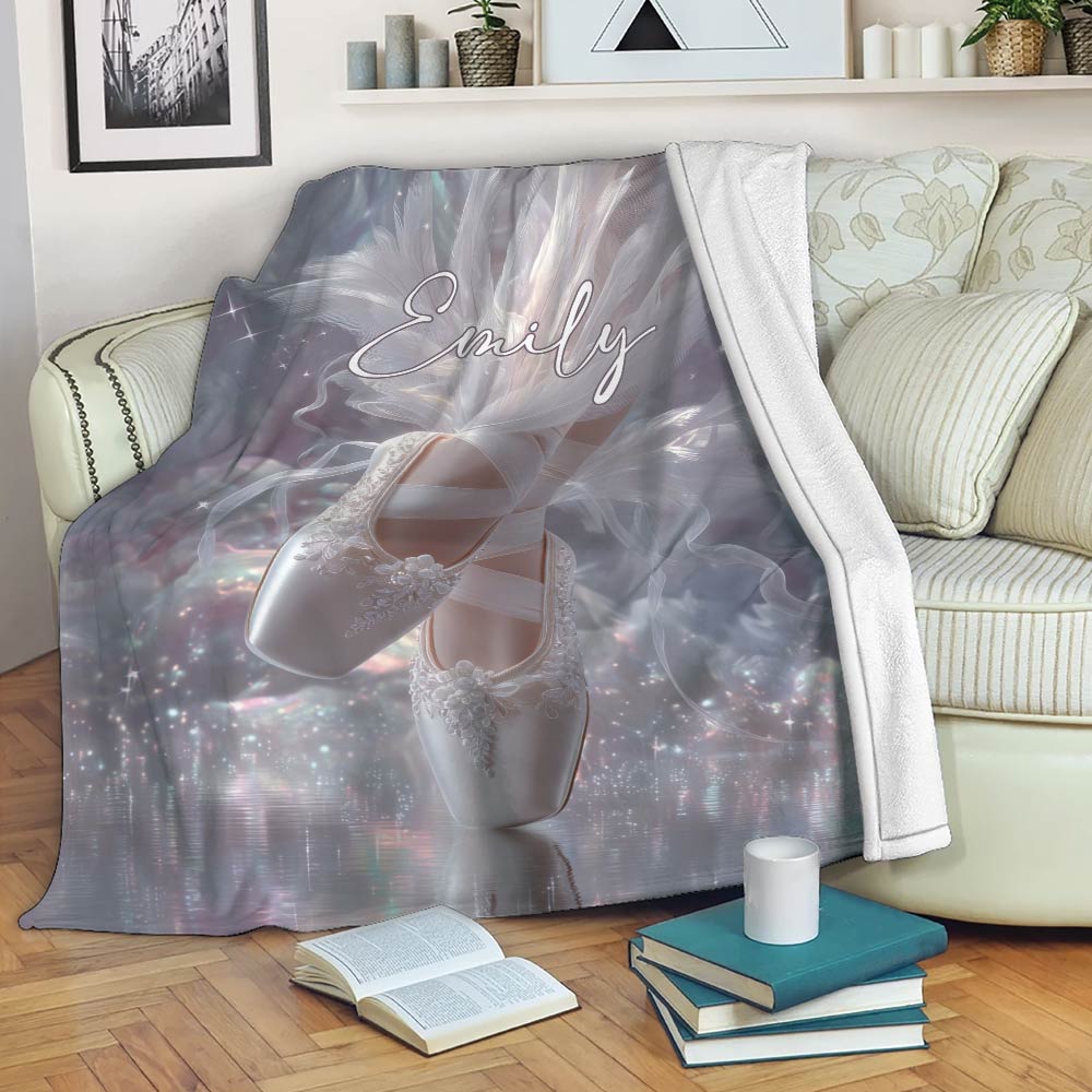 Ballet blanket displayed on a sofa with white ballet slippers, shimmering stars, and soft lavender artwork