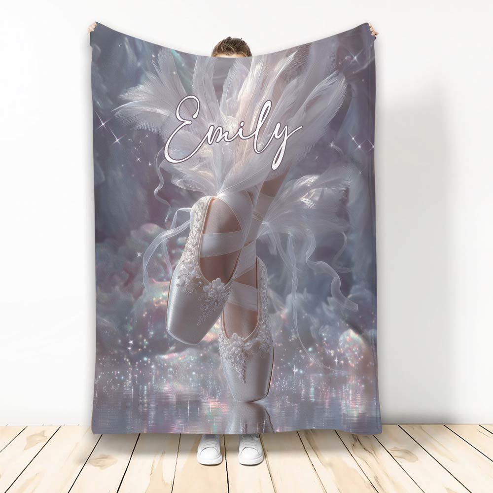 Ballet throw blanket featuring white ballet slippers, flowing feathers, stars, and dreamy lavender artwork
