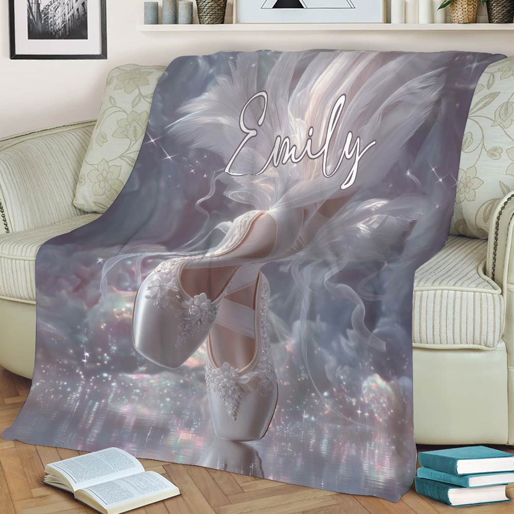 Ballerina throw blanket draped over a sofa with ballet slippers, feathers, and sparkling fantasy details