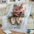 Close view of a ballet blanket featuring pink pointe shoes and a romantic floral design