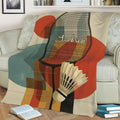 Close view of a badminton throw blanket with racket, shuttlecock, and abstract geometric design