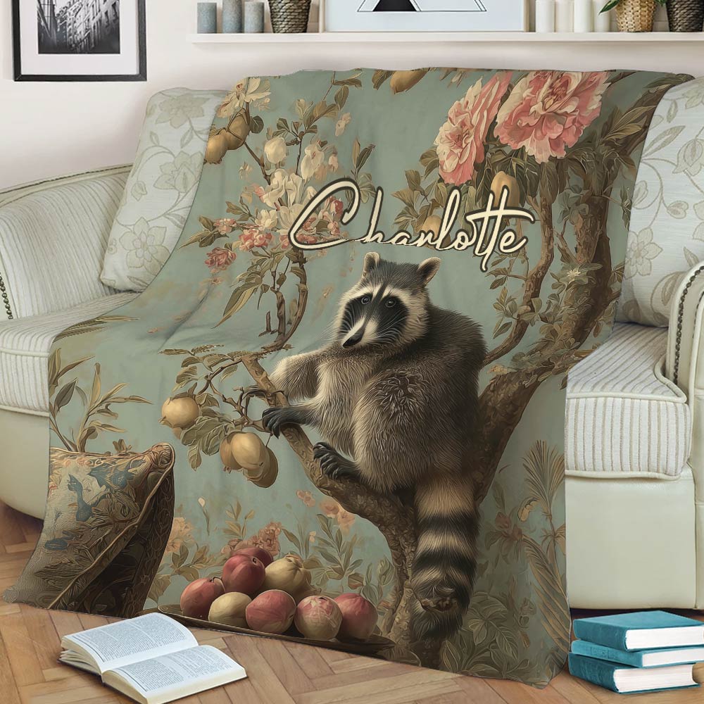 Woodland raccoon blanket featuring flowers, fruit trees, and ornate vintage artwork