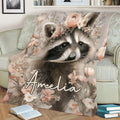Close view of a raccoon blanket with soft pink flowers on a living room sofa