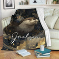 Otter blanket draped over a sofa with a dark celestial-inspired wildlife artwork