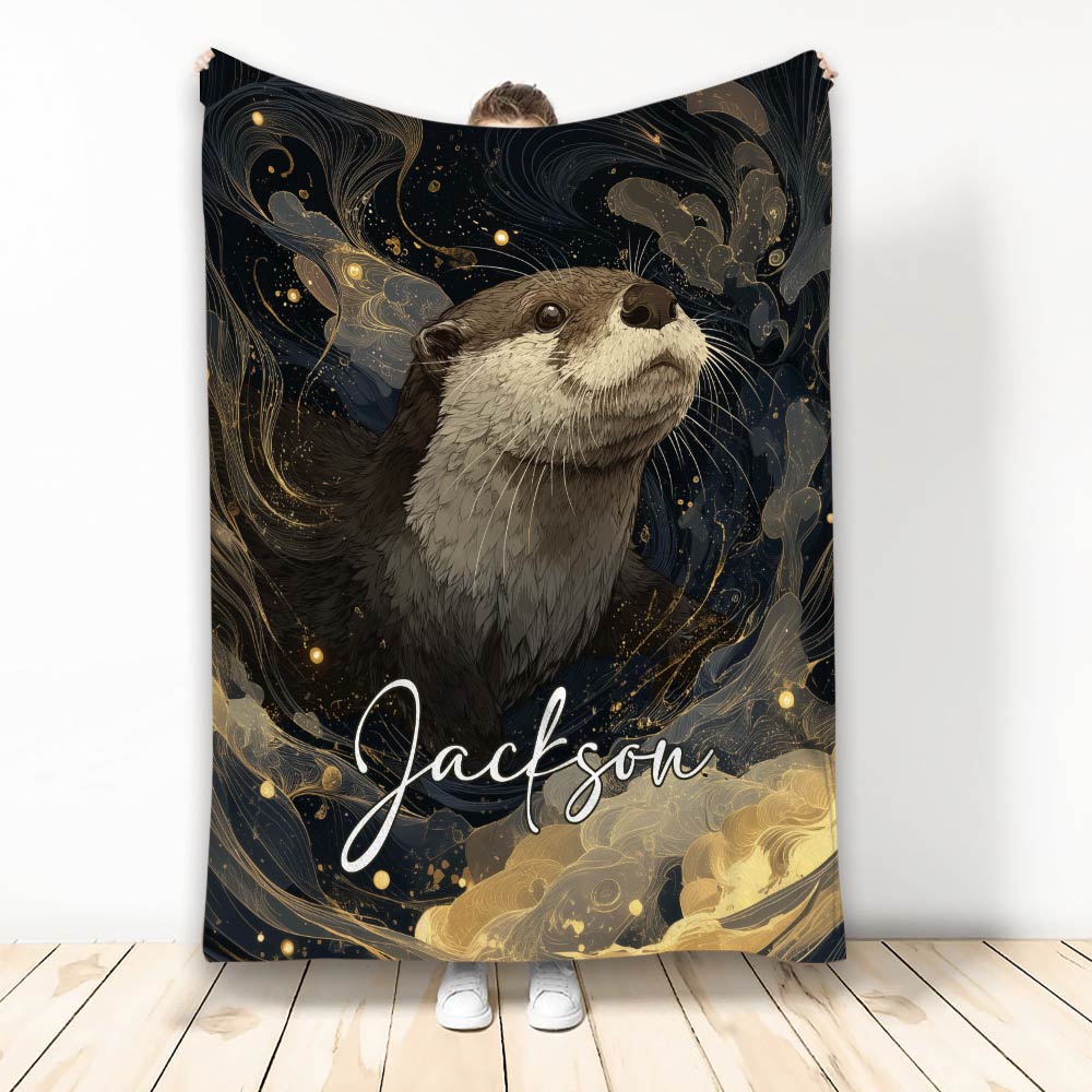 Otter throw blanket with an illustrated wildlife design in black, gold, and deep blue tones