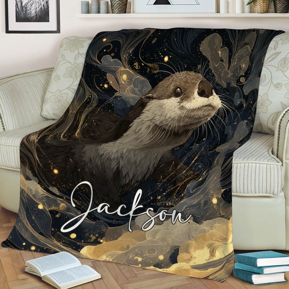 Decorative otter throw blanket displayed on a sofa with flowing gold and navy artwork