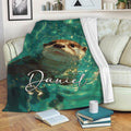 Otter blanket draped over a sofa with a swimming otter and vibrant teal aquatic artwork