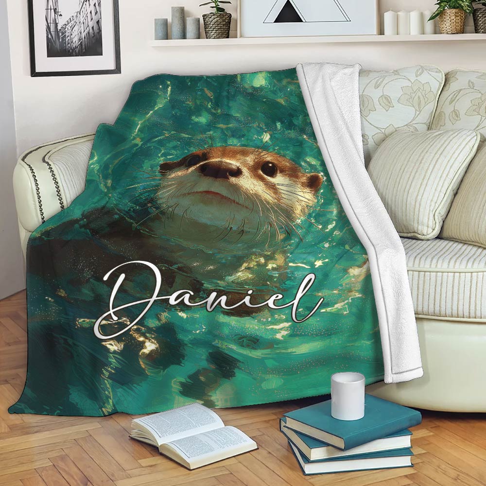 Otter blanket draped over a sofa with a swimming otter and vibrant teal aquatic artwork