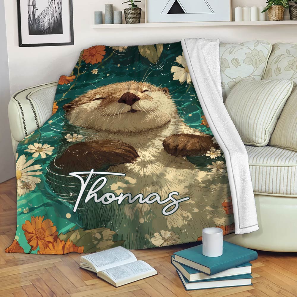 Otter throw blanket draped across a sofa with a cheerful floral wildlife design