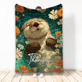 Otter throw blanket featuring a playful illustrated otter surrounded by orange and cream flowers