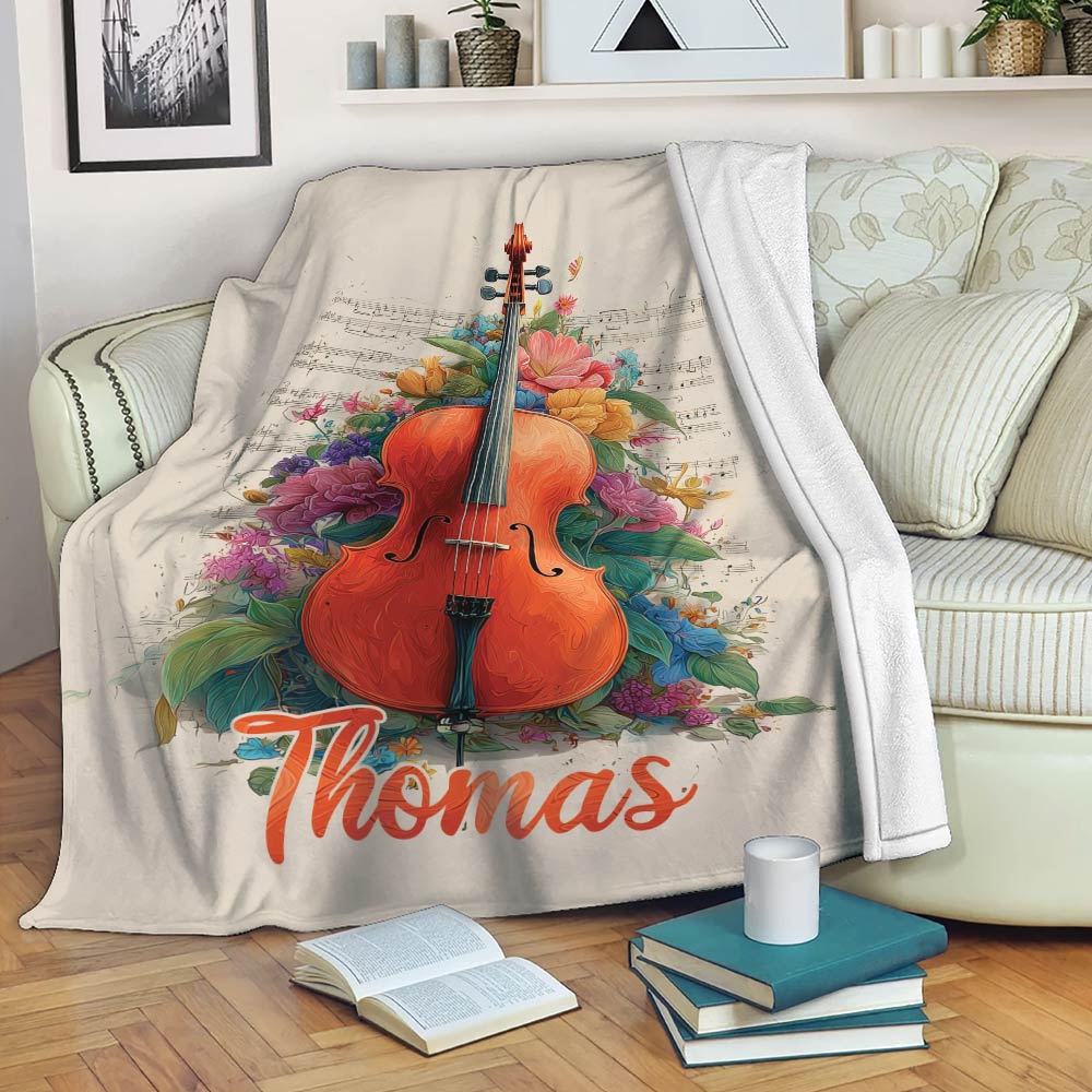 Cello throw blanket draped over a sofa with vibrant floral and musical note design
