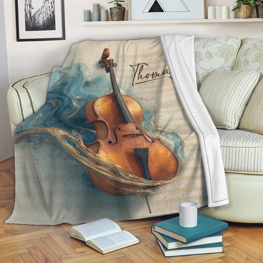 Cello throw blanket draped over a sofa with sheet music artwork and flowing blue and gold accents