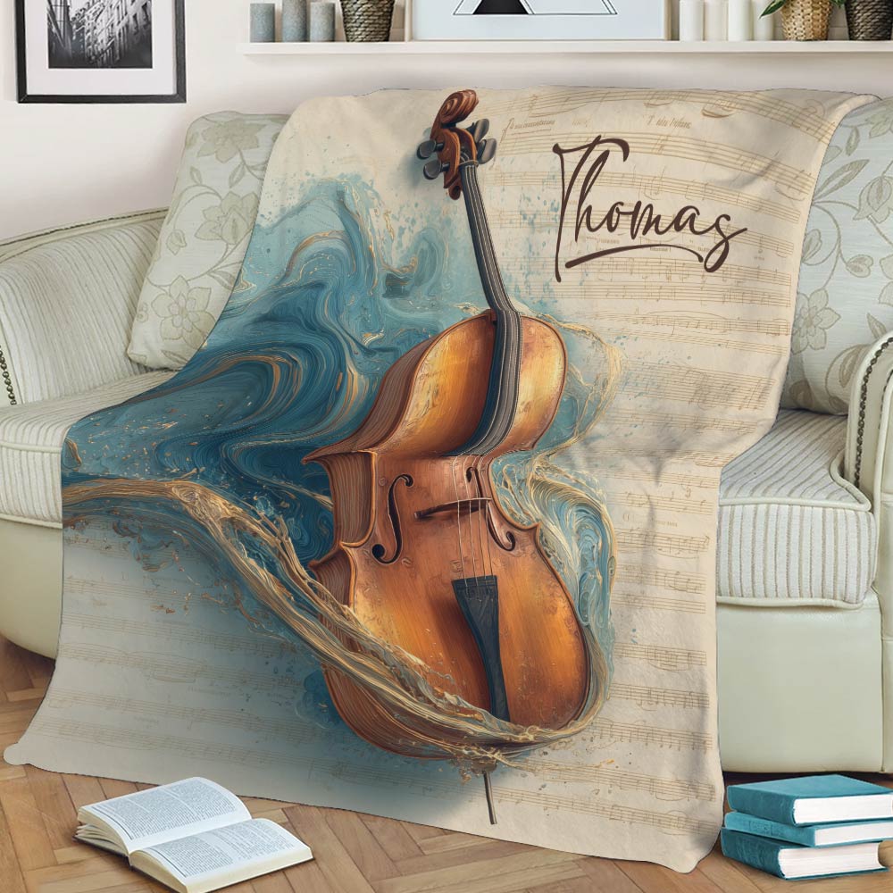 Cello blanket styled on a sofa, featuring a warm wooden cello against artistic sheet music