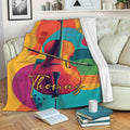 Colorful cello throw blanket draped over a sofa in a cozy living room