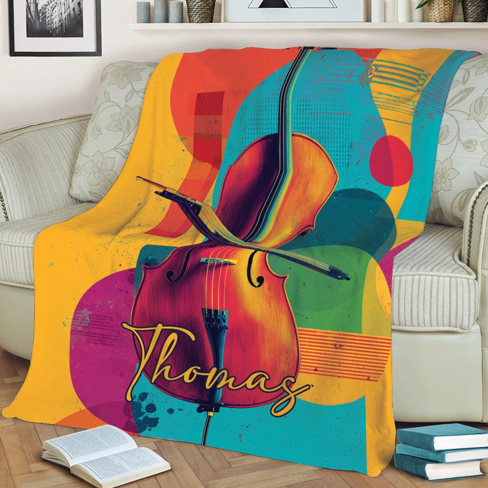 Vibrant cello and bow blanket displayed across a sofa with geometric artwork