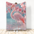 Pink flamingo throw blanket displayed with soft blue and coral tropical water artwork