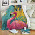 Flamingo throw blanket draped over a sofa with vibrant tropical artwork