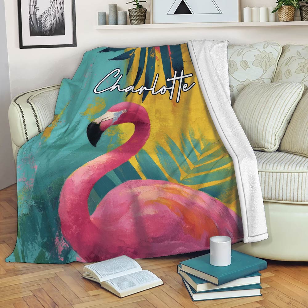 Flamingo throw blanket draped over a sofa with vibrant tropical artwork